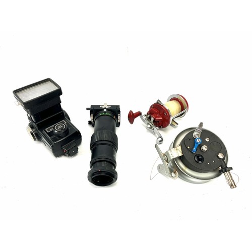 300A - Two fishing reels and a two camera accessories. Comprising a Makinon Zoom Slide Duplicator, a Vivata... 