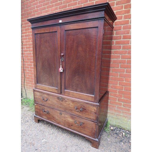 750A - A Georgian mahogany linen press, the panelled doors opening onto loose shelves, above two long cock-... 