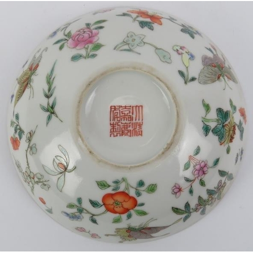 10 - A Chinese famille rose cup and saucer, early 19th century. Both decorated with butterflies amongst f... 