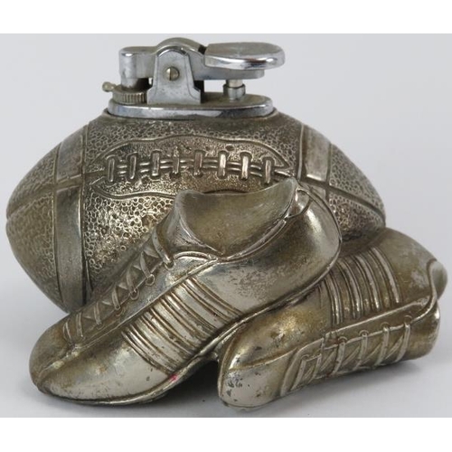 240 - A vintage novelty American football desk top lighter. Cast in metal as a ball and boots. 11 cm lengt... 