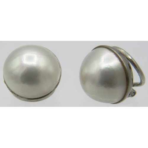 345 - A pair of 18ct white gold Mabe pearl earrings with spring backs. Pearl approx 18mm across, approx we... 