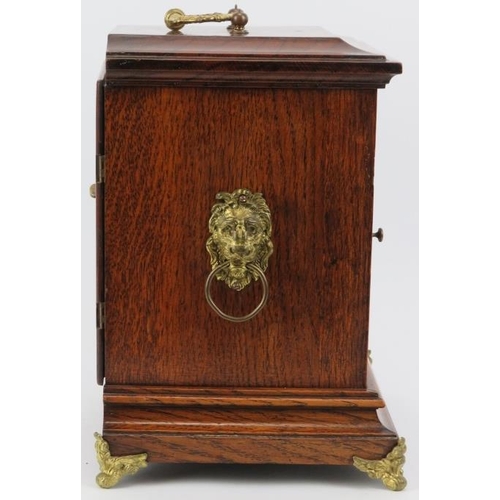 42 - An English oak and gilt brass mounted mantle clock, late 19th/early 20th century. Dial with Roman nu... 