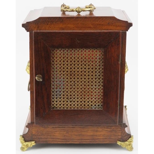 42 - An English oak and gilt brass mounted mantle clock, late 19th/early 20th century. Dial with Roman nu... 