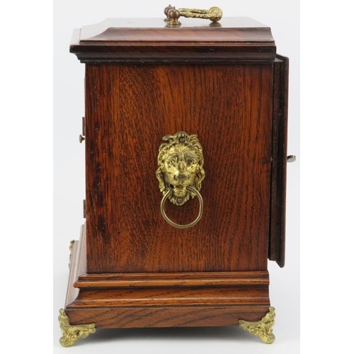 42 - An English oak and gilt brass mounted mantle clock, late 19th/early 20th century. Dial with Roman nu... 