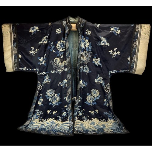 32 - A Chinese ladies embroidered silk robe, 19th century. With Peking knot and silk sewn elaborate embro... 