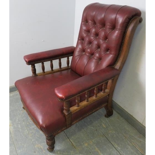 701 - A late Victorian mahogany library chair, having scrolled back and turned spindles, re-upholstered in... 