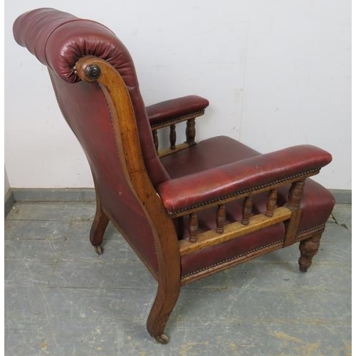 701 - A late Victorian mahogany library chair, having scrolled back and turned spindles, re-upholstered in... 