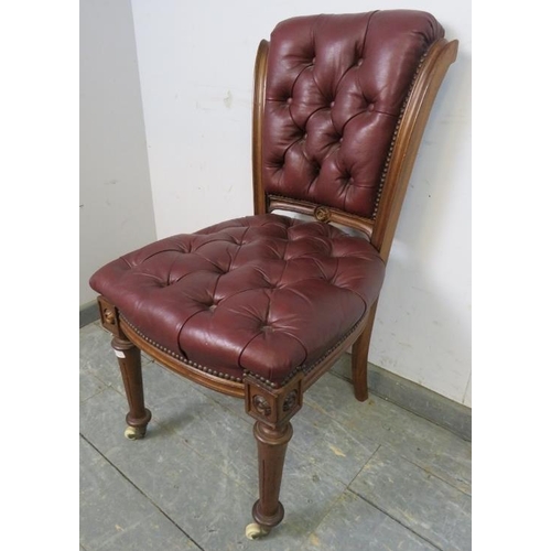 702 - A 19th Century walnut occasional chair, re-upholstered in buttoned burgundy leather with brass studs... 