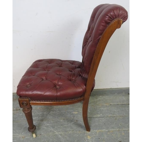 702 - A 19th Century walnut occasional chair, re-upholstered in buttoned burgundy leather with brass studs... 