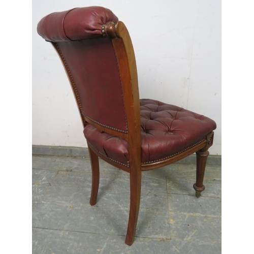 702 - A 19th Century walnut occasional chair, re-upholstered in buttoned burgundy leather with brass studs... 