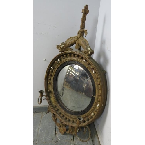 707 - A Regency Period convex girandole wall mirror, within an ornate gilt gesso surround, the cornice mod... 