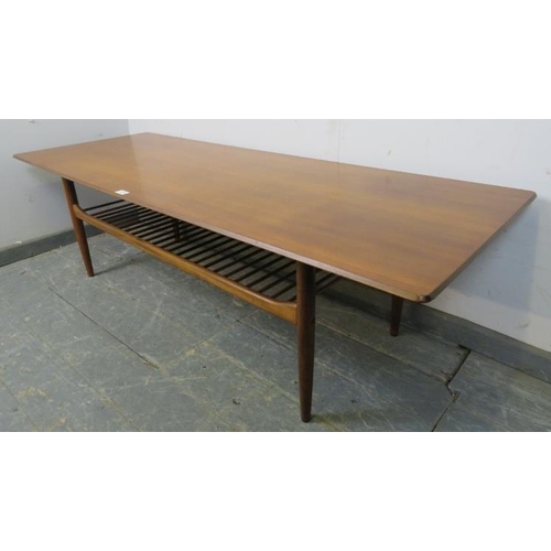 709 - A mid-century teak rectangular coffee table by Kofod Larsen for G-plan, on tapered supports with a s... 