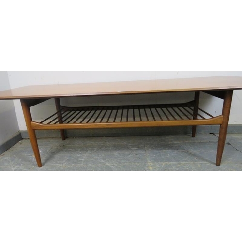 709 - A mid-century teak rectangular coffee table by Kofod Larsen for G-plan, on tapered supports with a s... 