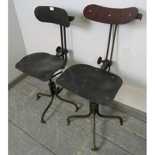 711 - A pair of early 20th century height-adjustable machinist’s stools, also having height-adjustable bac... 