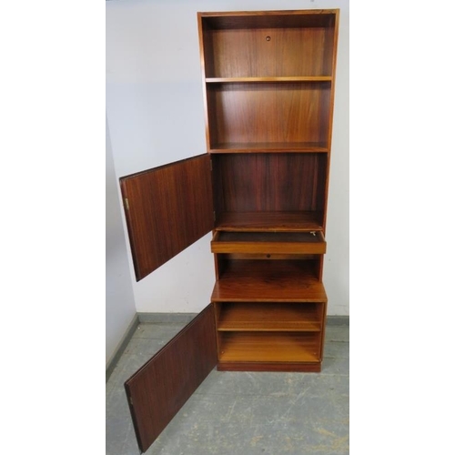 715 - A mid-century tall narrow tropical hardwood bookcase by Omman Jun, having two open shelves above cro... 