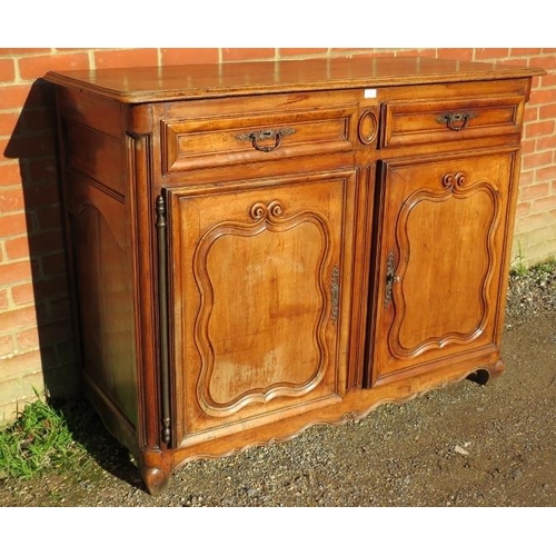 720 - An 18th century and later French fruitwood sideboard, housing two short drawers above cupboards with... 