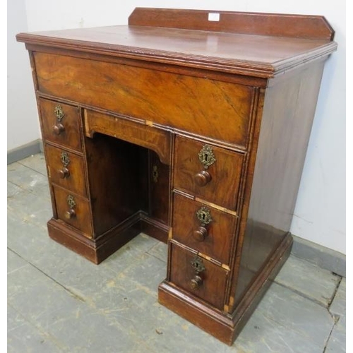 722 - An 18th century and later walnut and oak ladies’ kneehole desk, housing central blind drawer above a... 