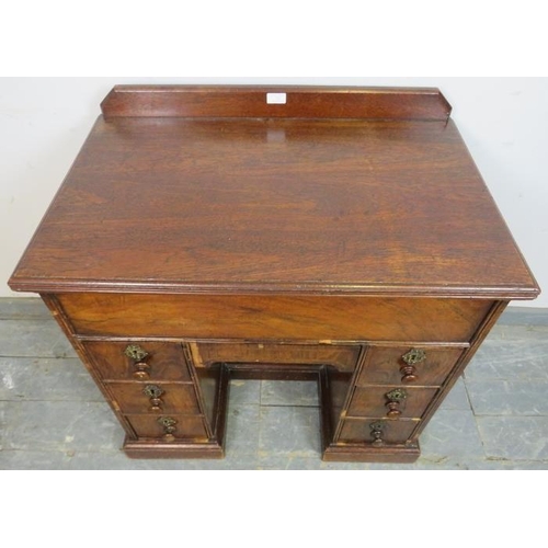 722 - An 18th century and later walnut and oak ladies’ kneehole desk, housing central blind drawer above a... 