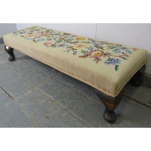 729 - An antique tapestry long footstool, on fruitwood ogee supports. c1920. 
H23cm W100cm D36cm (approx).... 