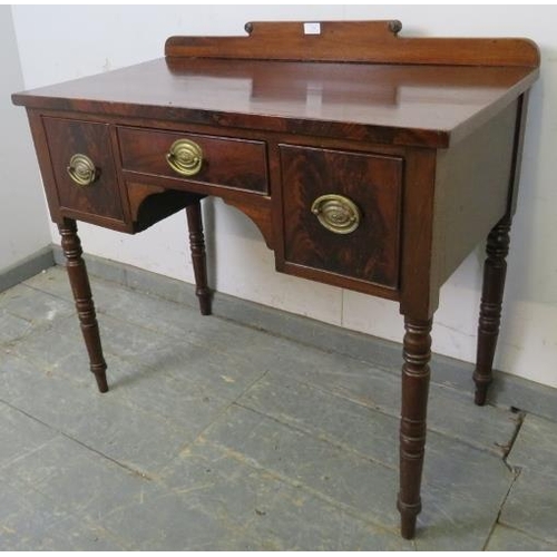 730 - A George IV mahogany lowboy, having shaped rear gallery with turned roundel decoration, housing thre... 