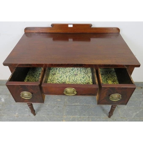 730 - A George IV mahogany lowboy, having shaped rear gallery with turned roundel decoration, housing thre... 