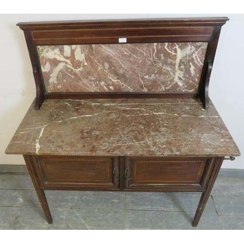 737 - An Edwardian mahogany washstand, parquetry strung and having rouge marble top and splash-back, above... 