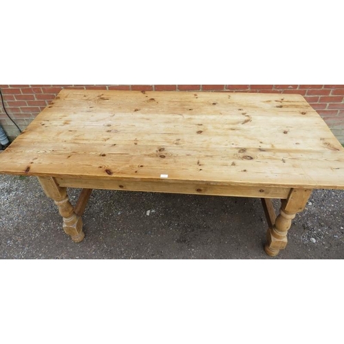 745 - An antique stripped pine farmhouse kitchen table, the planked top on baluster turned and block suppo... 