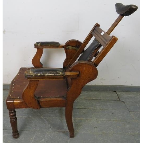 748 - A turn of the century walnut barber’s chair, having adjustable backrest and headrest, both with bras... 