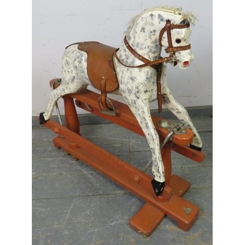 749 - A vintage rocking horse on stand, hand-painted in dapple grey with leather saddle and bridle. 
H86cm... 