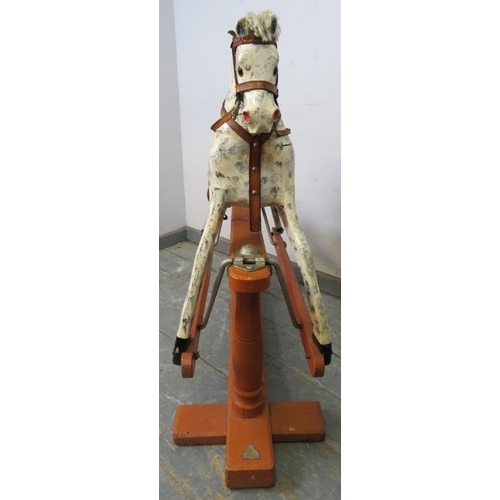 749 - A vintage rocking horse on stand, hand-painted in dapple grey with leather saddle and bridle. 
H86cm... 