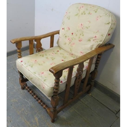 750 - An antique Continental beech and ash wheelback reclining armchair, having carved and pierced sides a... 