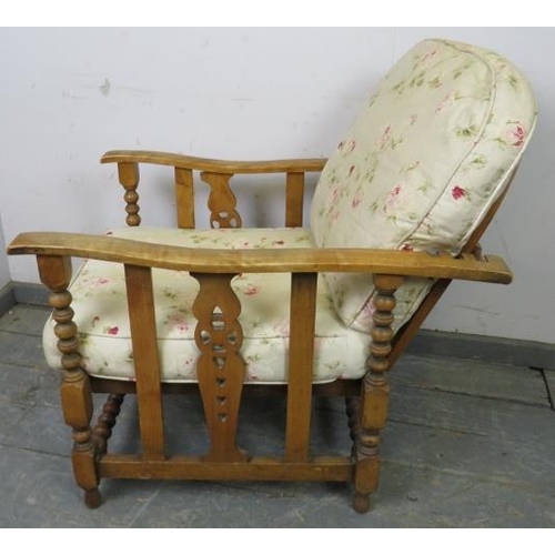 750 - An antique Continental beech and ash wheelback reclining armchair, having carved and pierced sides a... 