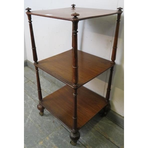 751 - A Victorian mahogany three tier freestanding whatnot, having onion finials and turned uprights, on t... 