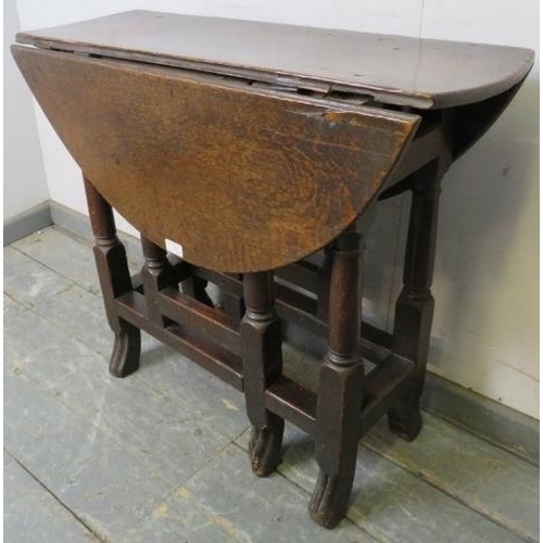 756 - An 18th century oak gate-leg table of small proportions, with single drawer, on turned and block sup... 