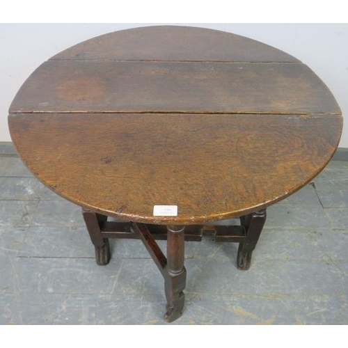 756 - An 18th century oak gate-leg table of small proportions, with single drawer, on turned and block sup... 