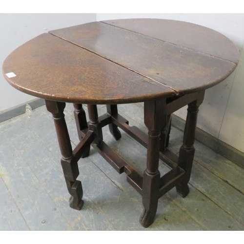 756 - An 18th century oak gate-leg table of small proportions, with single drawer, on turned and block sup... 