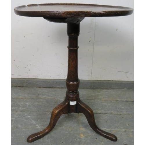 759 - An 18th century oak circular wine table of good colour and patina, the dished top on a tapering pede... 