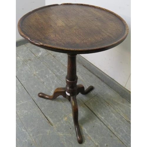 759 - An 18th century oak circular wine table of good colour and patina, the dished top on a tapering pede... 