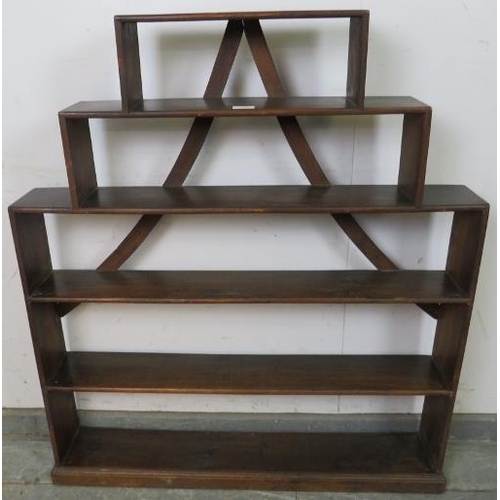 760 - An unusual 19th century mahogany stepped bookcase, of five open shelves with curved back braces, on ... 