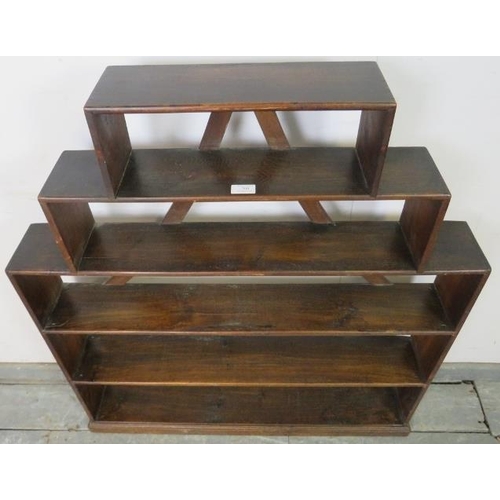 760 - An unusual 19th century mahogany stepped bookcase, of five open shelves with curved back braces, on ... 