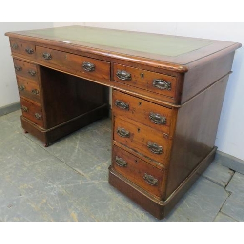 768 - A late Victorian mahogany pedestal desk, the inset green leather writing surface above a configurati... 