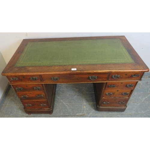 768 - A late Victorian mahogany pedestal desk, the inset green leather writing surface above a configurati... 