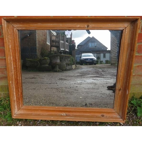 769 - An antique pitch pine wall mirror within a moulded rectangular surround. 
H70cm W80cm D7cm (approx).... 