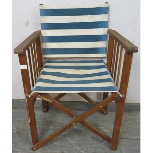 772 - A teak framed folding director’s chair, having blue and white striped canvas seat material. 
H85cm W... 