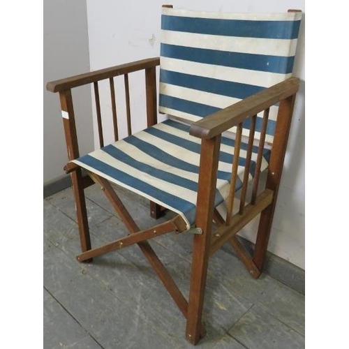 772 - A teak framed folding director’s chair, having blue and white striped canvas seat material. 
H85cm W... 