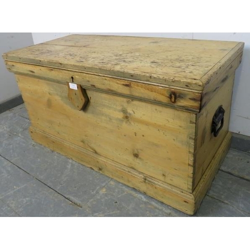 779 - An antique pine flat topped trunk/blanket box, having carry handles to either side, on a plinth base... 