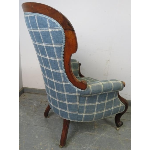 785 - A Victorian mahogany spoonback armchair, reupholstered in blue chequered woollen material, having sc... 