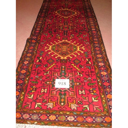 918 - North West Persian Heriz runner, central repeat pattern on a red ground, 395cm x .78cm.
Condition re... 