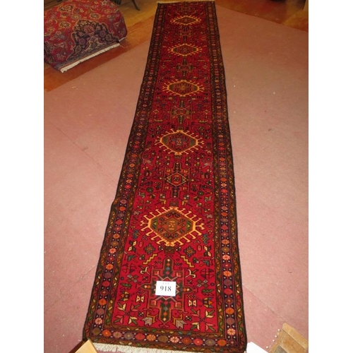 918 - North West Persian Heriz runner, central repeat pattern on a red ground, 395cm x .78cm.
Condition re... 