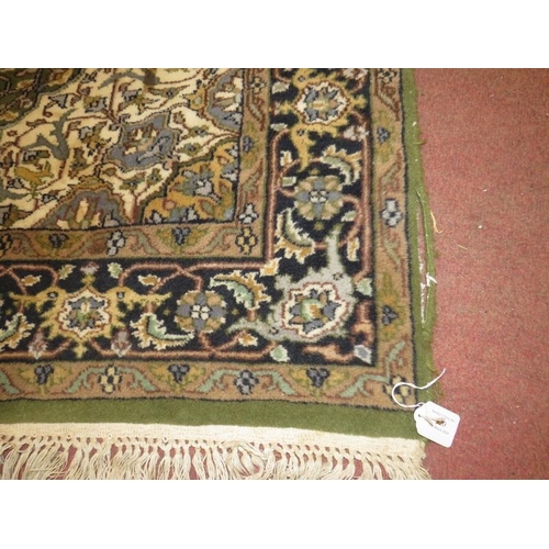 920 - A Persian carpet, central medallion on green ground, 182cm x 127cm.
Condition report: Generally in g... 